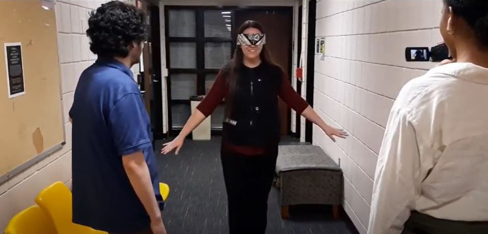 Kathryn Pagano wearing the vest with a blindfold on and navigating within engineering building 1